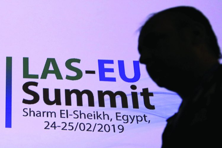 Egyptian man passes at the International Congress Centre a day before the first EU-Arab League Summit in Sharm El Sheikh